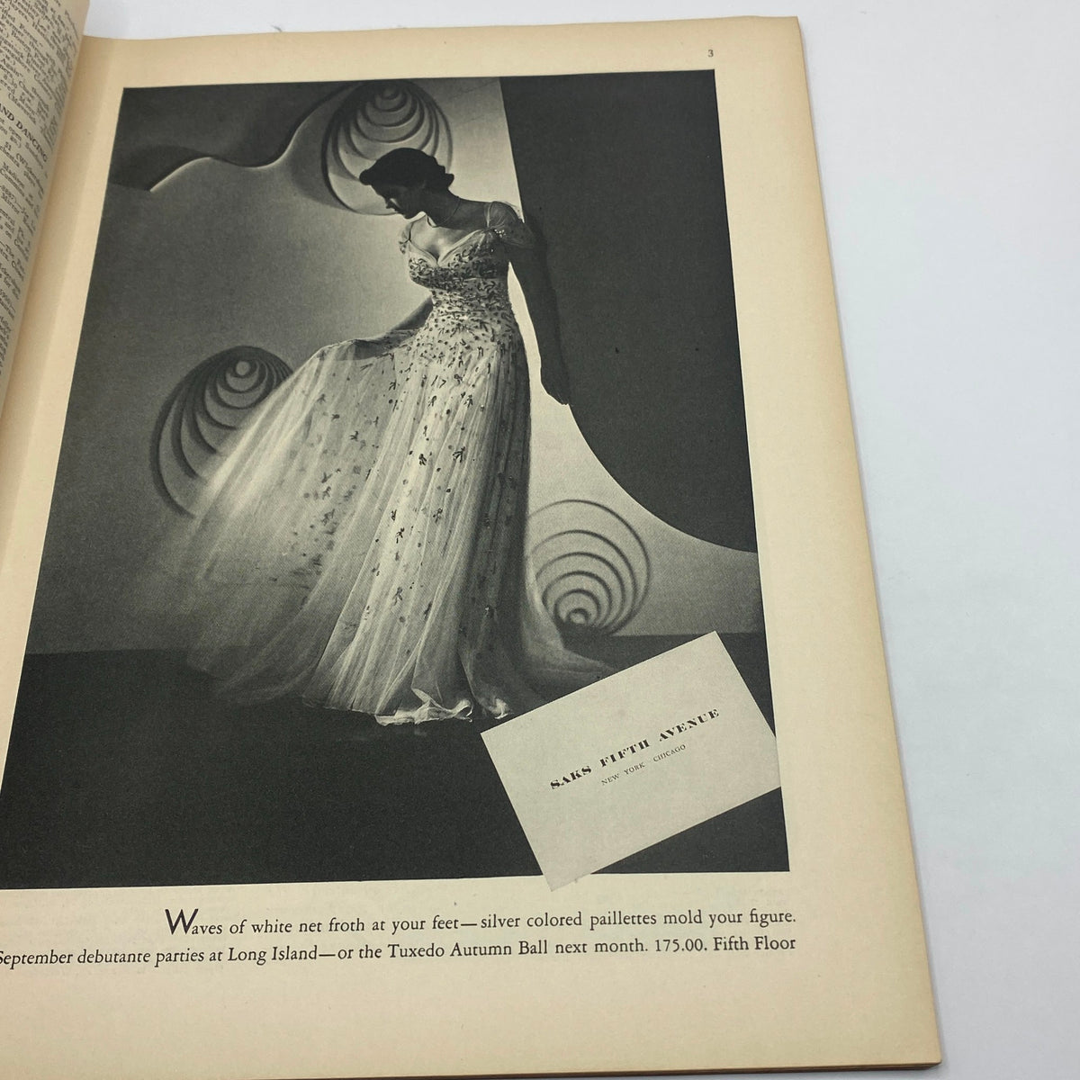 Promotional page from The New Yorker magazine September 4, 1937 showcasing an elegant dress advertisement for Saks Fifth Avenue with model details and event highlights.
