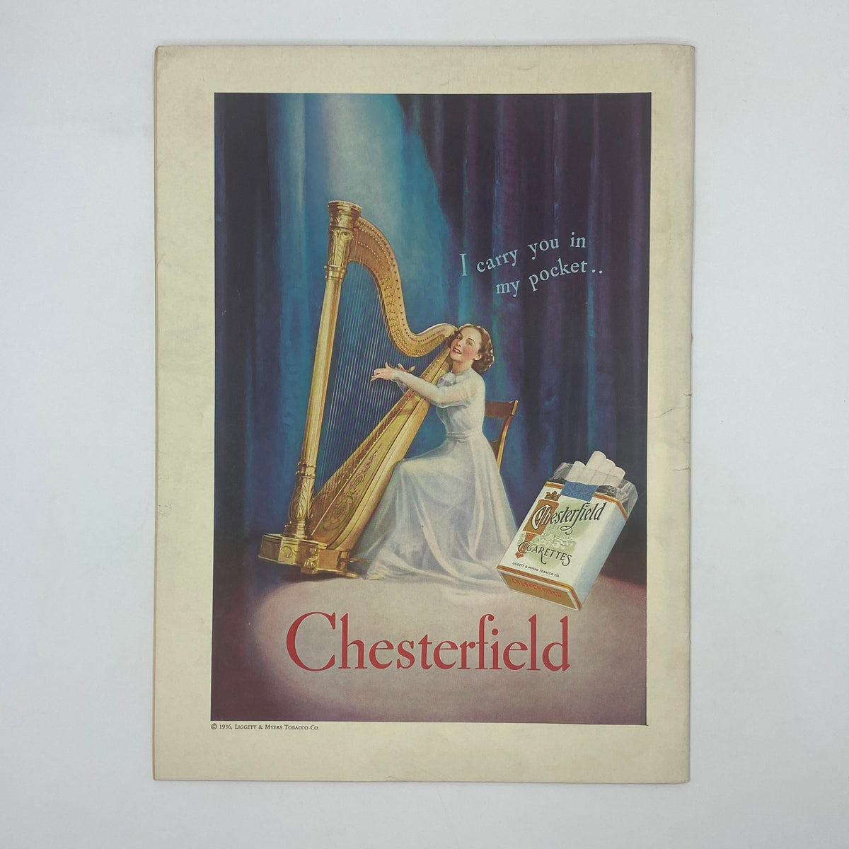 Vintage advertisement for Chesterfield cigarettes from The New Yorker Complete Magazine August 1, 1936 featuring a woman playing a harp.