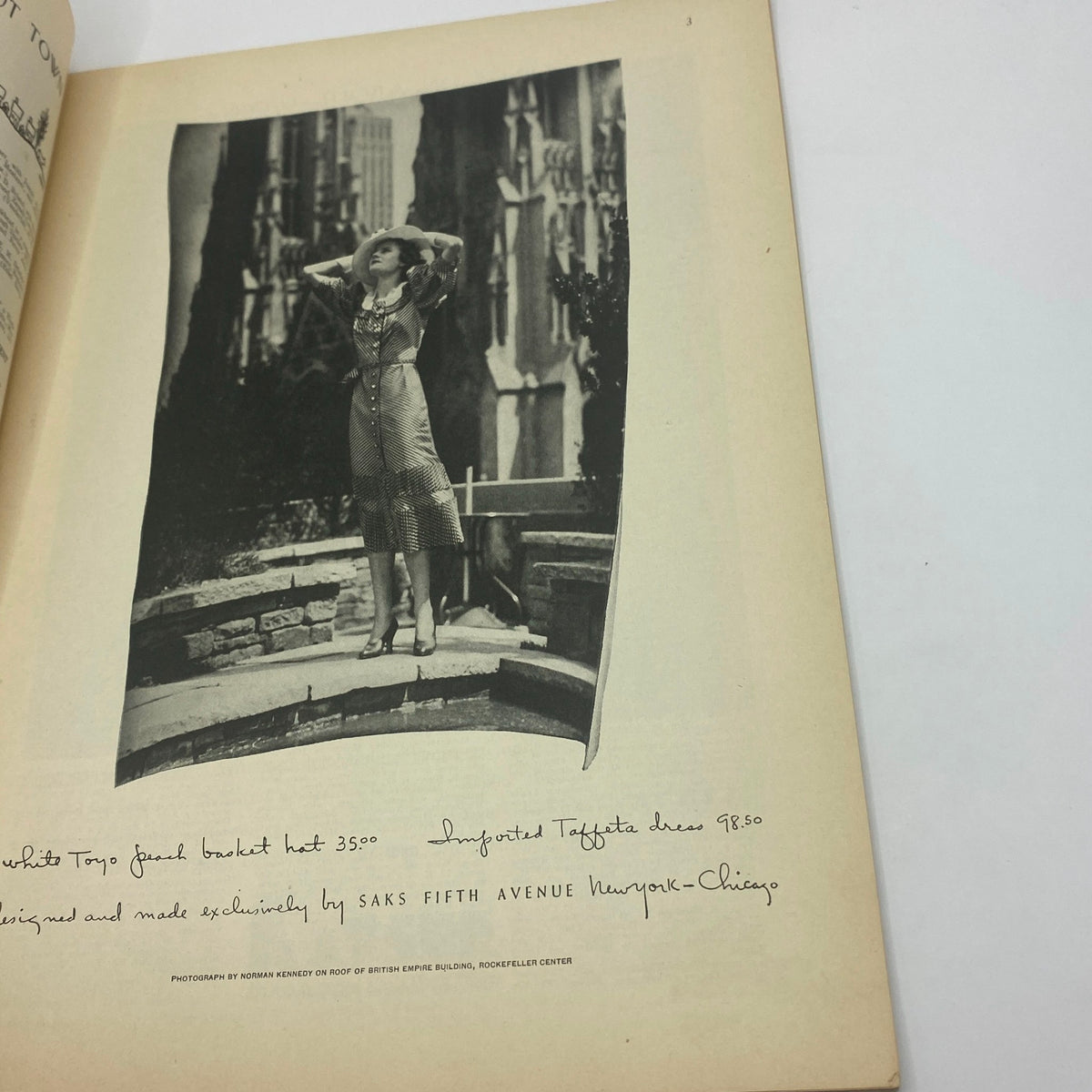 Fashion advertisement featuring a woman in a stylish dress posing outdoors; includes details about the hat and dress prices. From The New Yorker Complete Magazine May 4, 1935 Ilonka Karasz Cover.