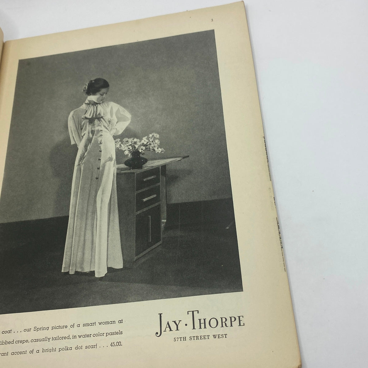 Fashion advertisement featuring a woman in a stylish white dress from The New Yorker Complete Magazine March 30, 1935, showcasing 1930s fashion trends.