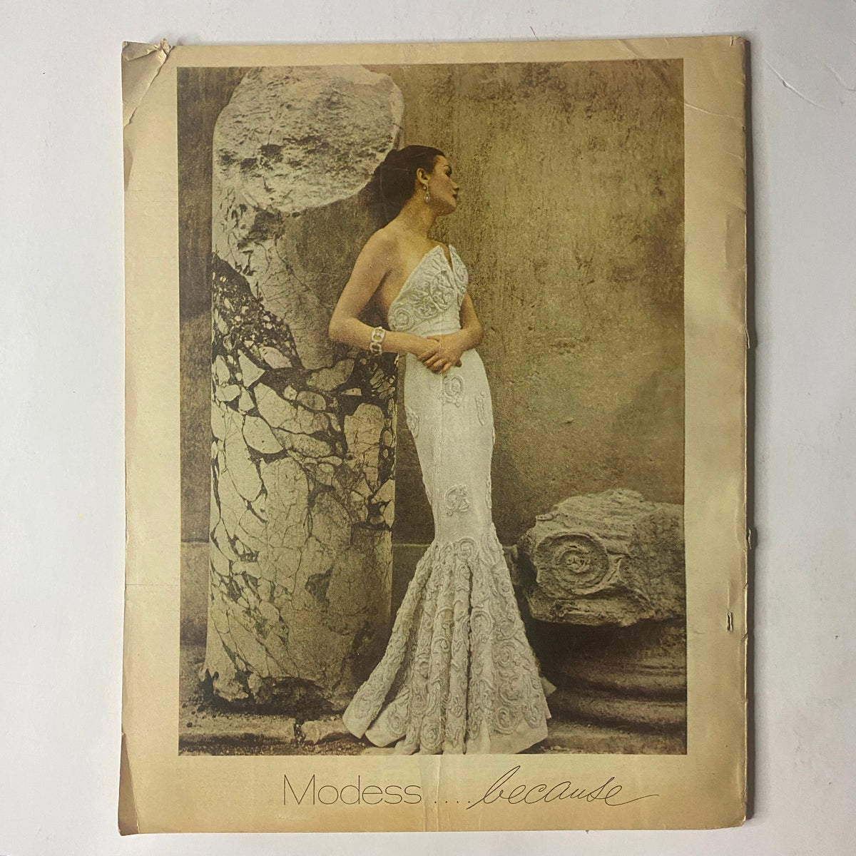 Fashion advertisement from the Radio and TV Mirror Magazine, showcasing a model in an elegant gown, emphasizing vintage clothing styles from the January 1950 issue.