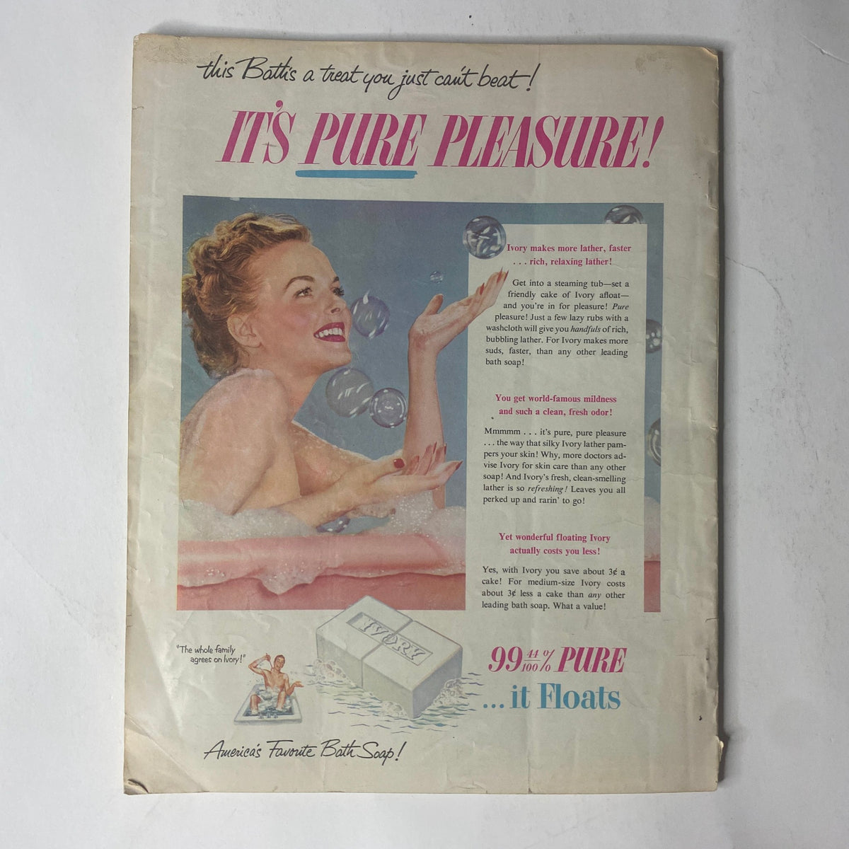 Vintage advertisement featuring a woman enjoying a bath surrounded by bubbles, promoting luxurious bathing experiences with the slogan 'IT'S PURE PLEASURE!' This image is part of the Radio-TV Mirror Magazine August 1952 edition featuring Toni Darnay and Johnnie Ray.