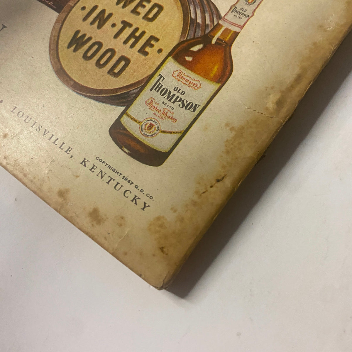 Close-up of the back cover of Field & Stream Magazine September 1947, showcasing Old Thompson liquor advertisement with detailed graphics, part of the issue titled 'The New Game Laws 1947 - 1948'.