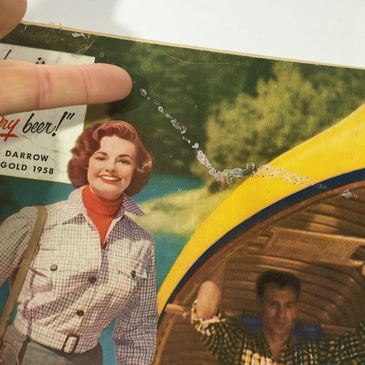Close-up view of the back cover of VTG Gourmet The Magazine of Good Living July 1958 - High-Style Barbecue, highlighting a vintage advertisement for Rheingold Extra Dry Lager Beer with details of wear and tear.