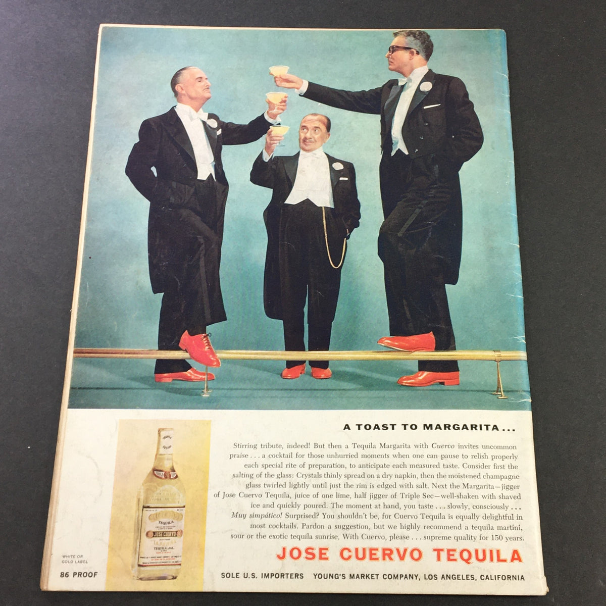 Image from VTG Gourmet The Magazine of Good Living June 1959, featuring three elegantly dressed men toasting with cocktails, showcasing a vintage advertisement for Jose Cuervo Tequila, highlighting the joy of margaritas.