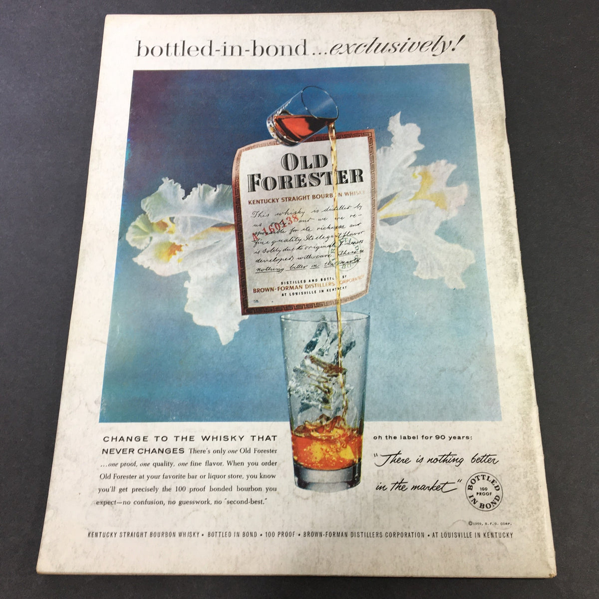 Back cover of VTG Gourmet The Magazine of Good Living, April 1959 featuring an advertisement for Old Forester bourbon, showcasing a glass filled with bourbon and an elegant label, emphasizing quality and tradition in a vintage style.