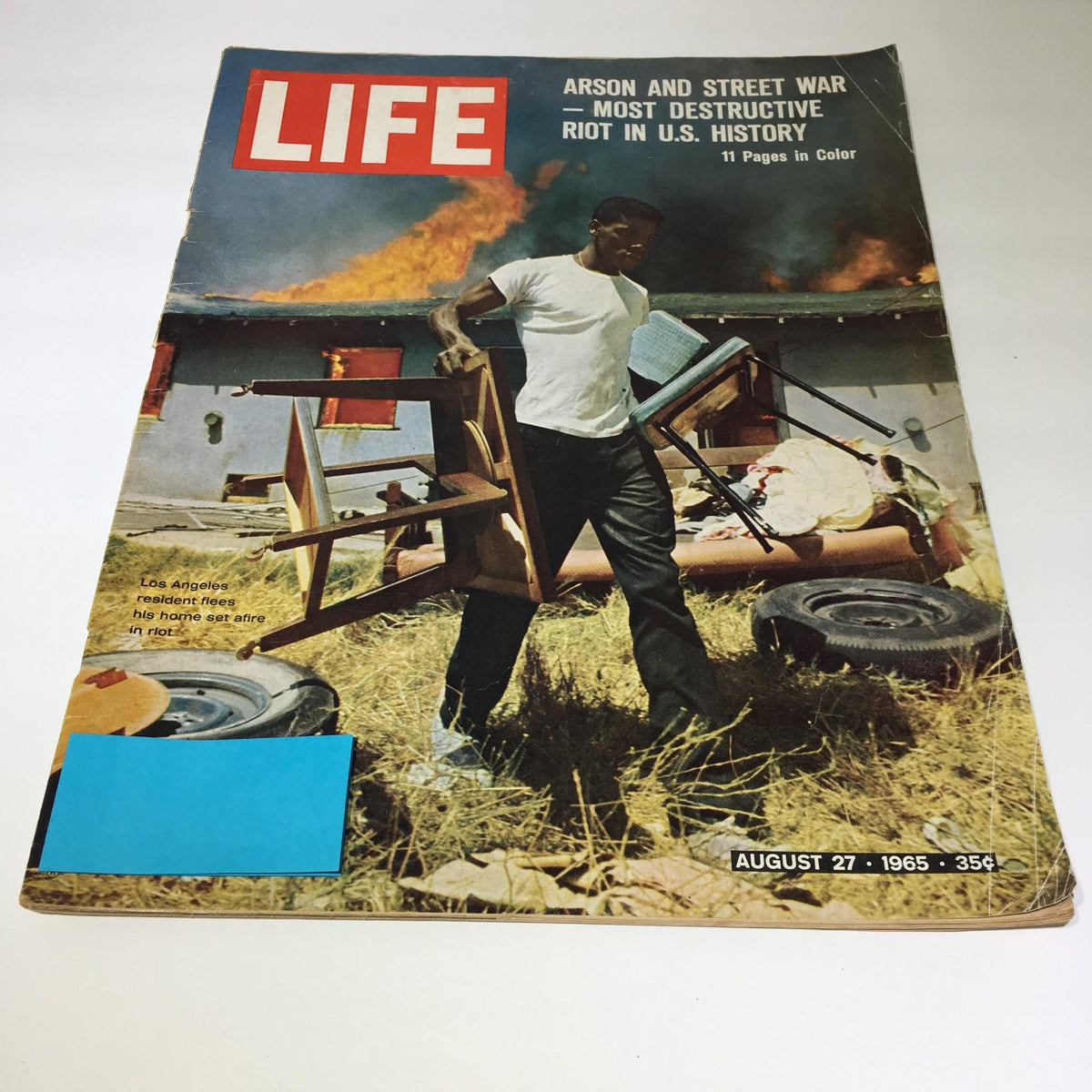 Cover of Life Magazine, August 27, 1965, featuring the title 'Arson and Street War - Most Destructive Riot in U.S. History', showing a man carrying furniture away from a burning building amidst chaos.