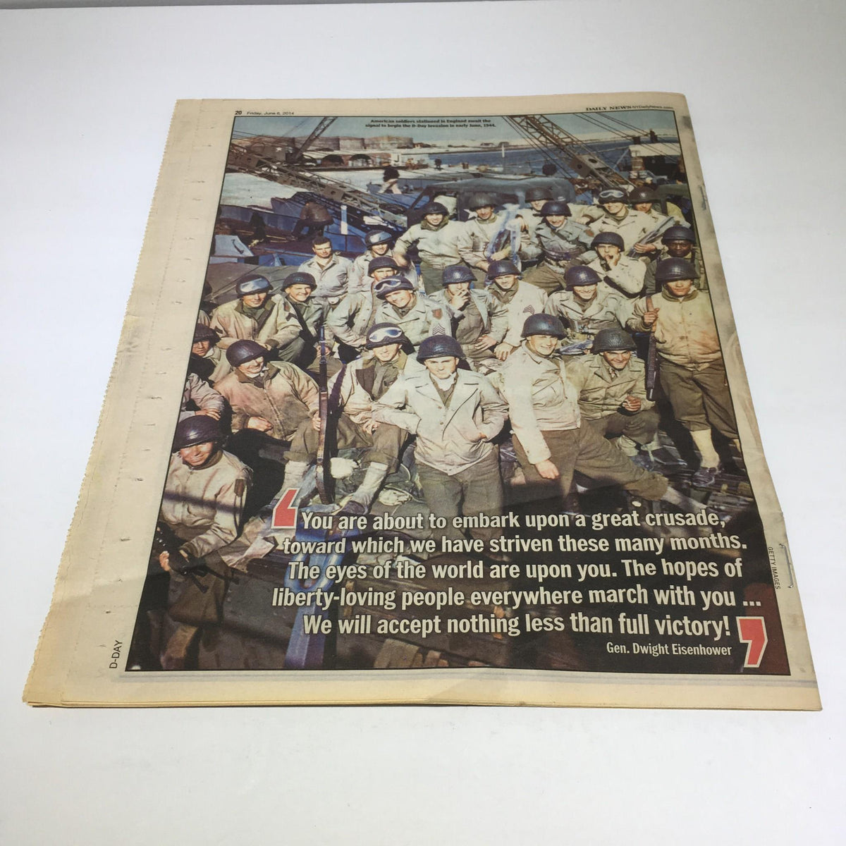New York Daily News: June 6, 2014 features a historic photograph of soldiers preparing for D-Day, accompanied by a quote from Gen. Dwight Eisenhower about embarking on a great crusade.