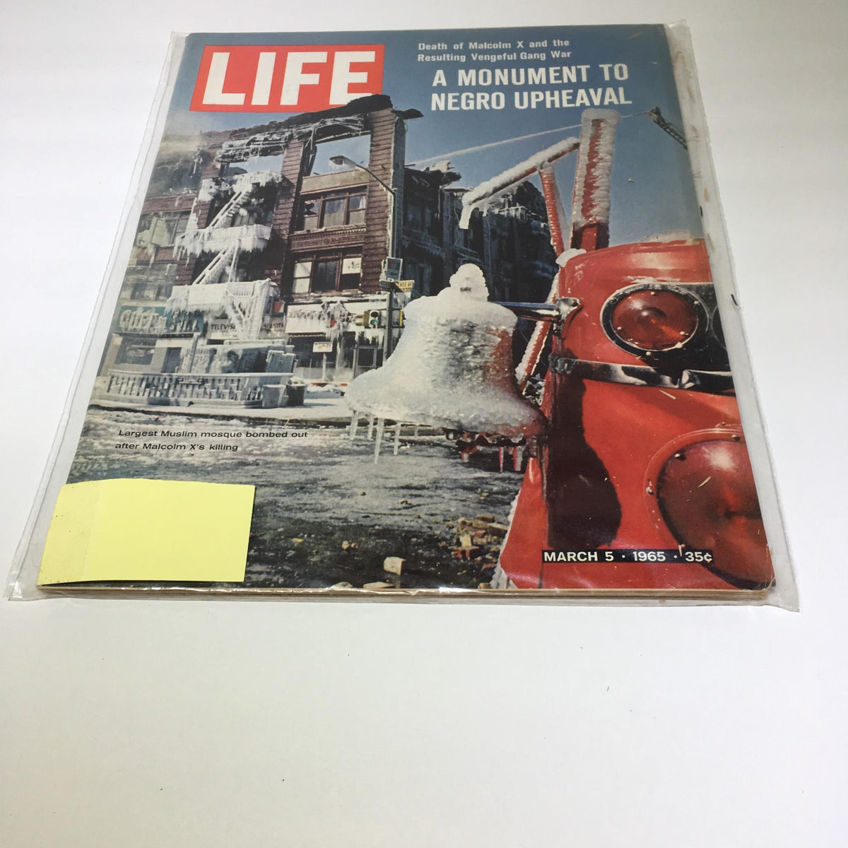 Vintage Life Magazine cover from March 5, 1965, titled 'Life Magazine: 3/5/65 Largest Muslim Mosque Bombed Out After Malcolm X's Killing'. The cover features a dramatic scene with icy streets and a fire truck, highlighting significant events surrounding the bombing of a mosque after Malcolm X's assassination, a pivotal moment in American civil rights history.
