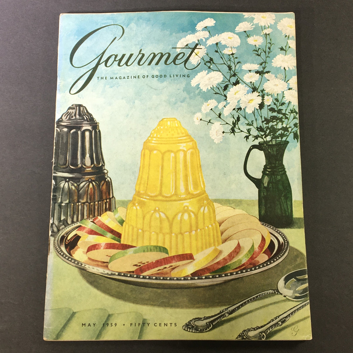 Cover of VTG Gourmet The Magazine of Good Living May 1959 featuring a yellow gelatin dessert with slices of fruit and a floral arrangement, embodying the theme of a 'Potpourri of Scents.'