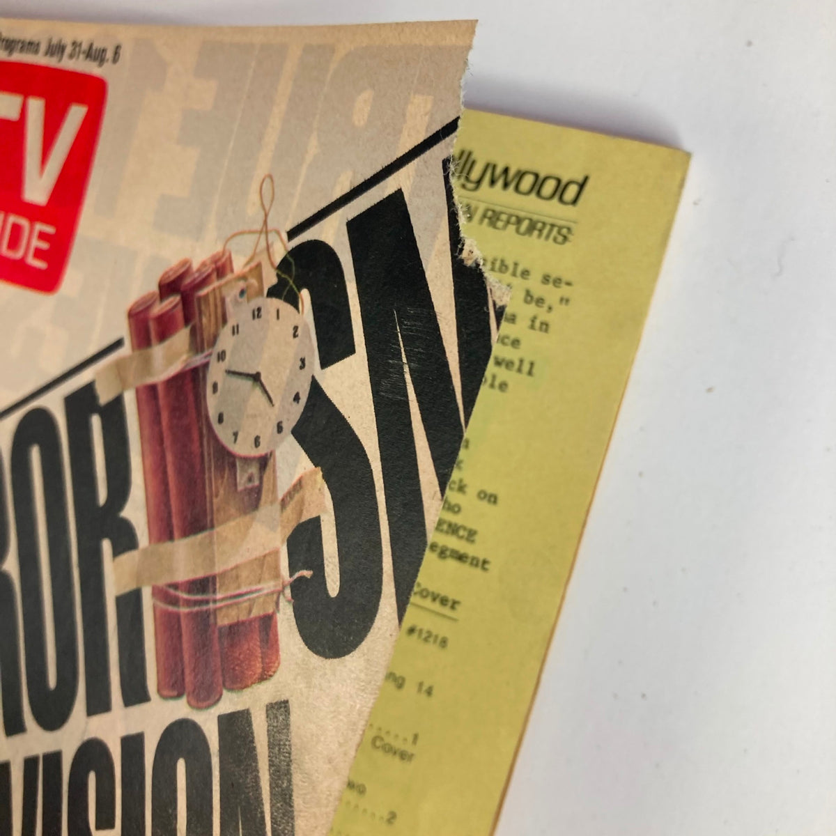 Close-up of the cover of TV Guide Magazine July 31 1976 #1218 showing the title 'Terrorism and Television' with visible wear, hinting at its vintage status as a collectible magazine.