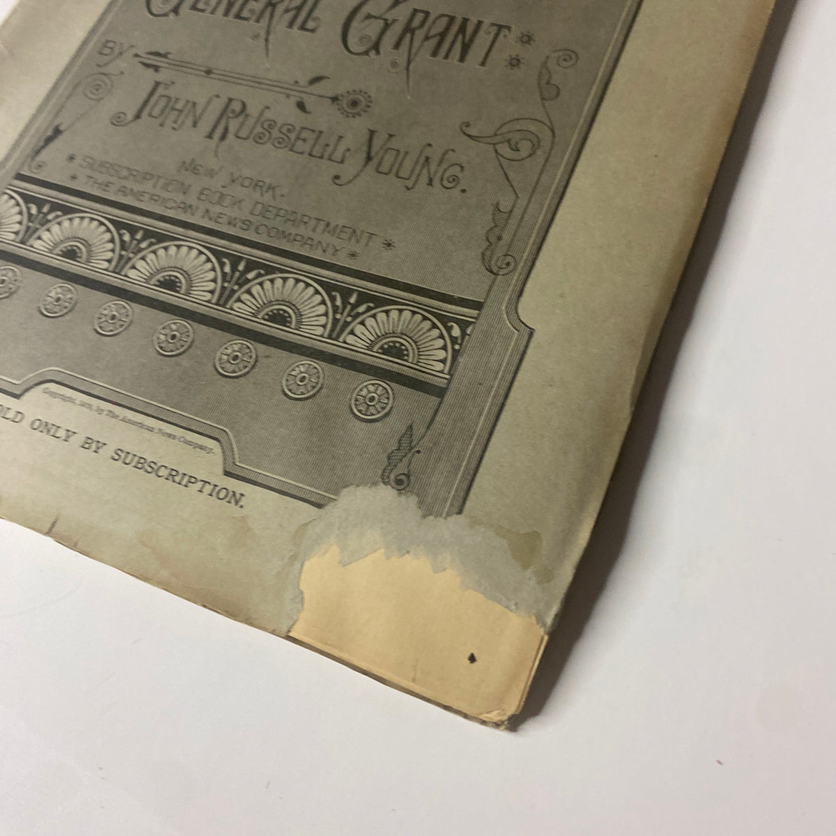 Close-up view of 'Around the World with General Grant' Book by John Russell Young, Part Five, highlighting the lower corner damage on the cover.