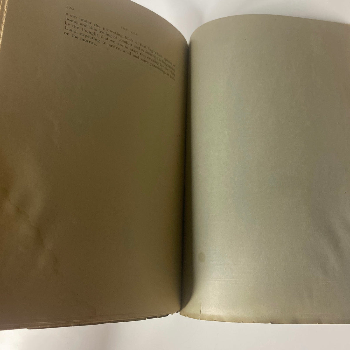 Interior page of 'Around the World with General Grant' by John Russell Young, showcasing worn edges and faded text, indicative of the book's vintage condition.