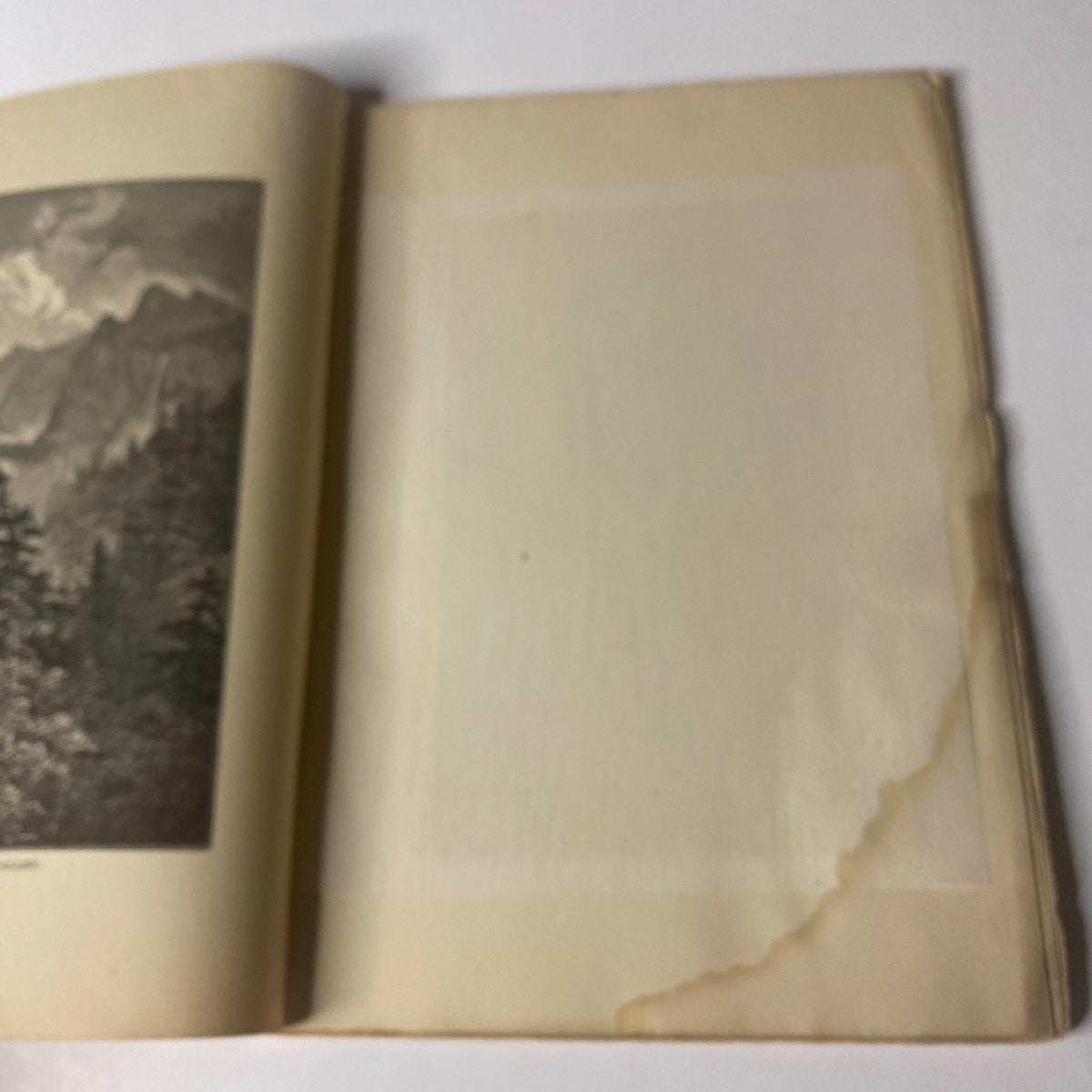 Interior page of Around the World with General Grant Book by John Russell Young, displaying a blank page with a curled corner.