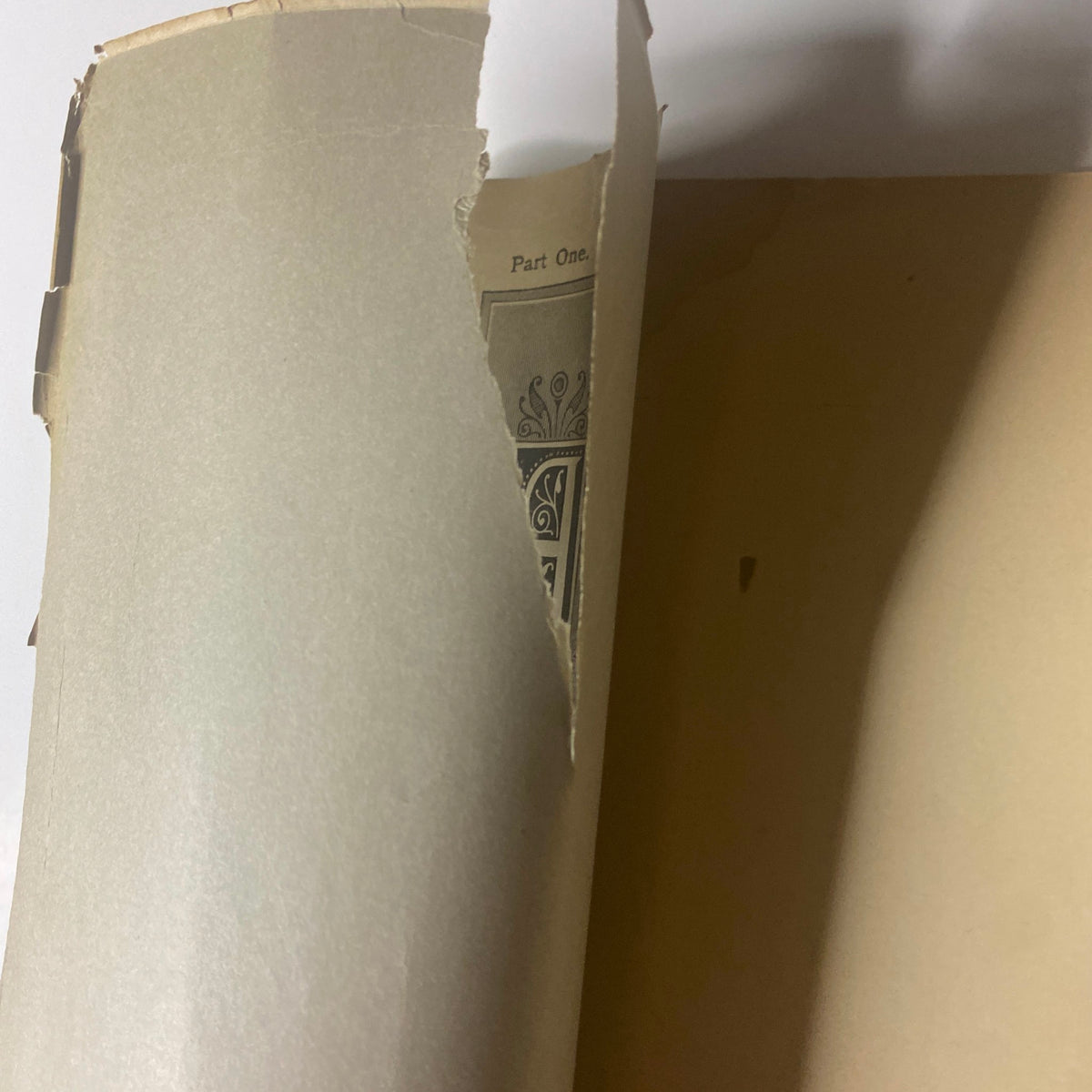 Inside view of 'Around the World with General Grant by John Russell Young, Part One', showing a torn page and part of the cover.