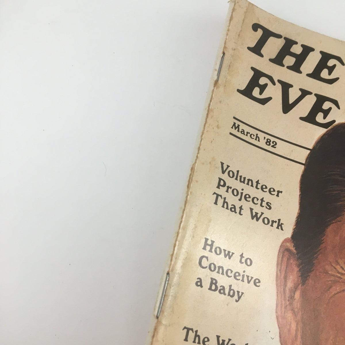 Close-up detail of the March 1982 edition of The Saturday Evening Post showcasing the magazine's spine with text outlining featured articles such as volunteer projects and parenting advice.