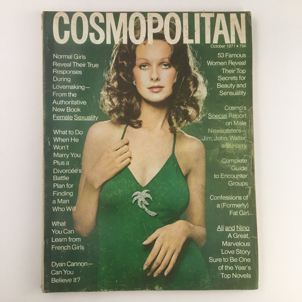 Cover of Cosmopolitan Magazine October 1971 featuring Susan Forrestal in a green dress, showcasing vintage fashion and beauty trends.