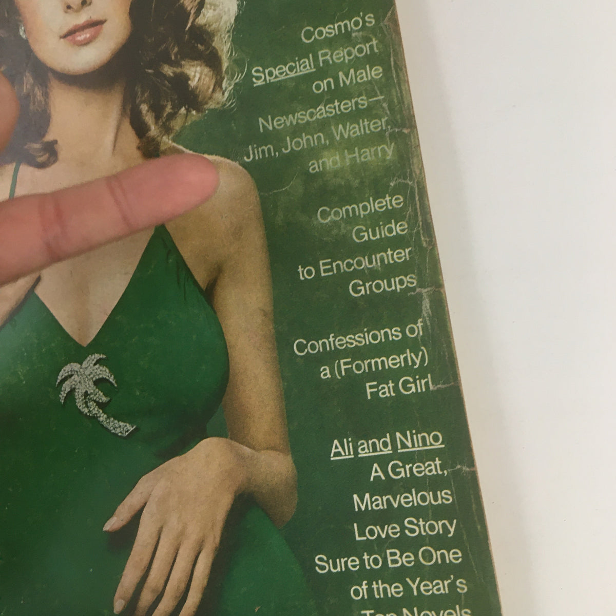 Close-up view of Cosmopolitan Magazine October 1971 cover, highlighting text details about women's topics and features.