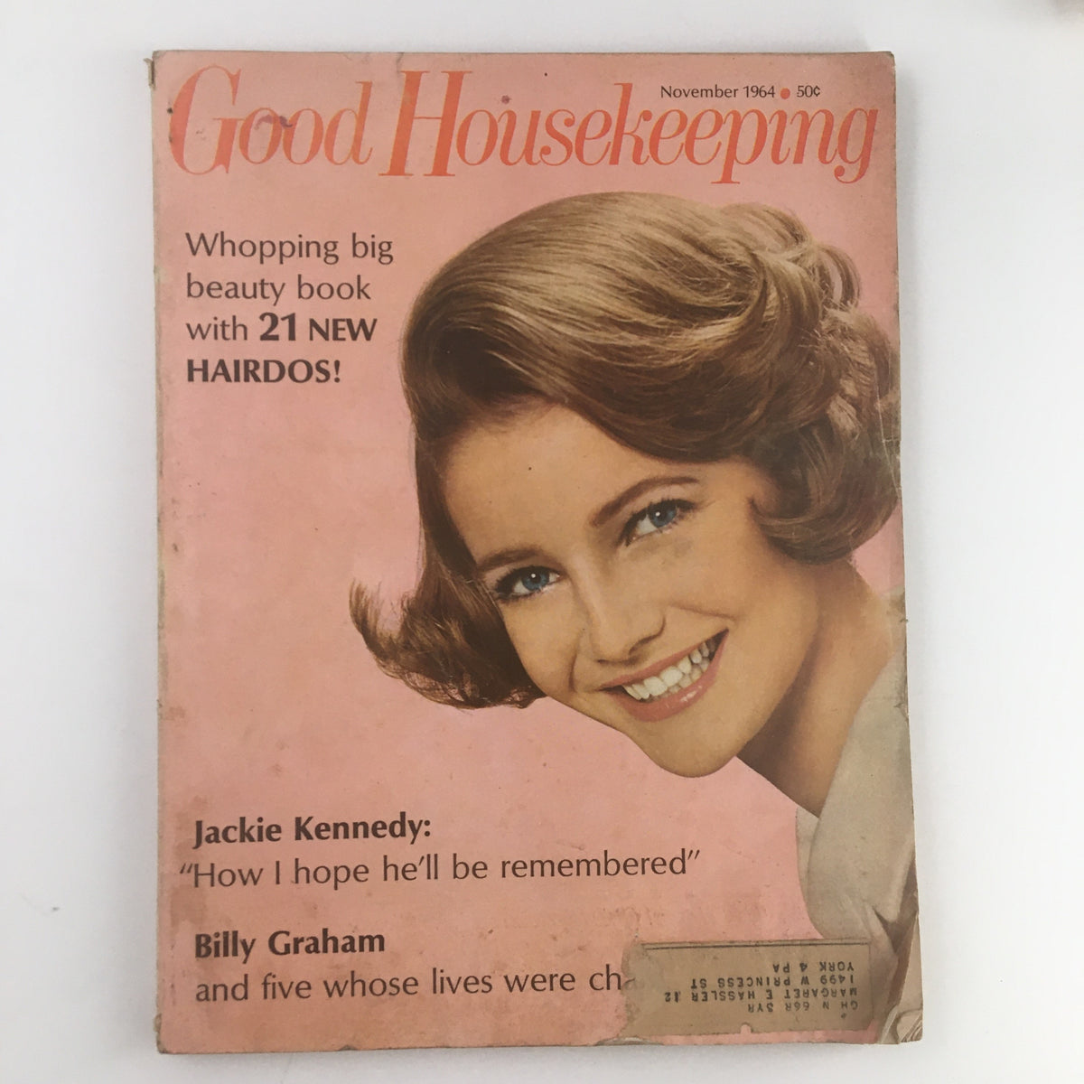 Cover of Good Housekeeping Magazine November 1964 featuring Jackie Kennedy and Billy Graham, highlighting beauty tips with the tagline 'Whopping big beauty book with 21 NEW HAIRDOS!'.