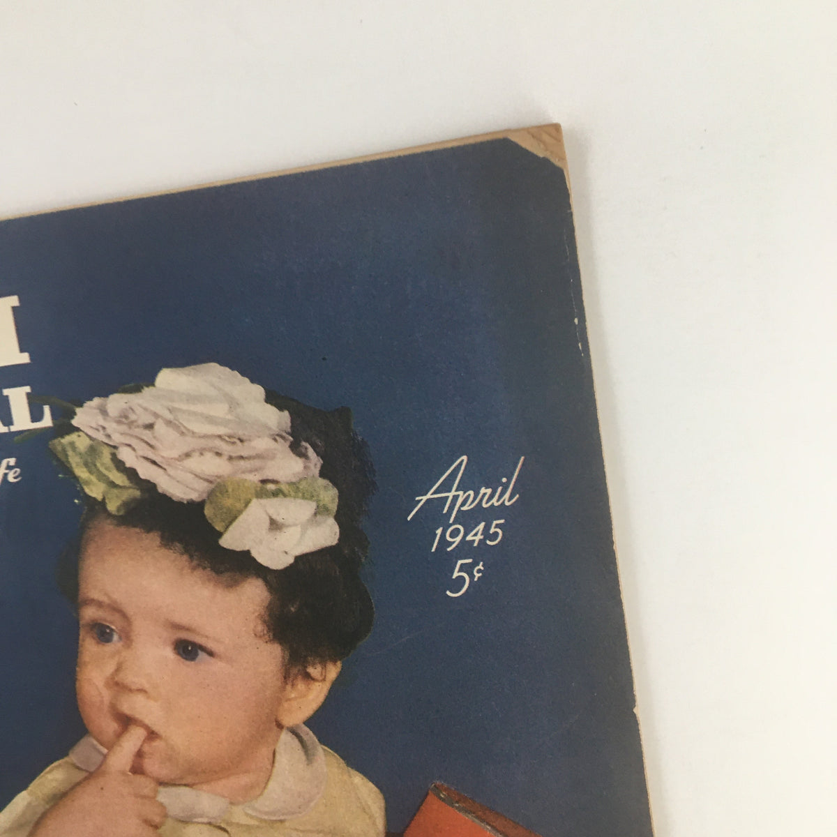 Close-up of the Farm Journal and Farmer's Wife April 1945 cover showing a child with floral decorations, emphasizing historic agriculture.
