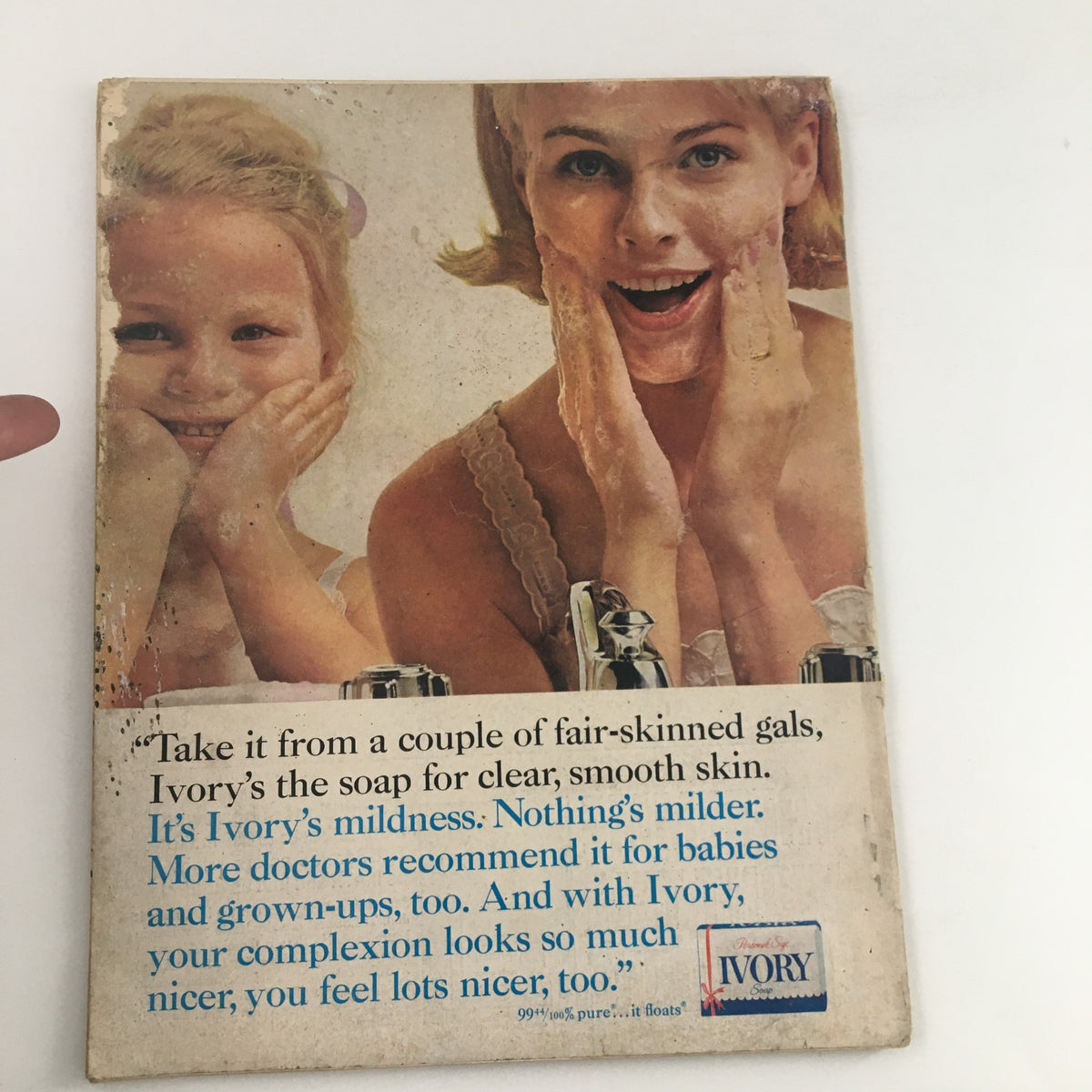 Back cover of Photoplay Magazine April 1964 featuring an Ivory soap advertisement with two women demonstrating the product, emphasizing its mildness and suitability for all ages.