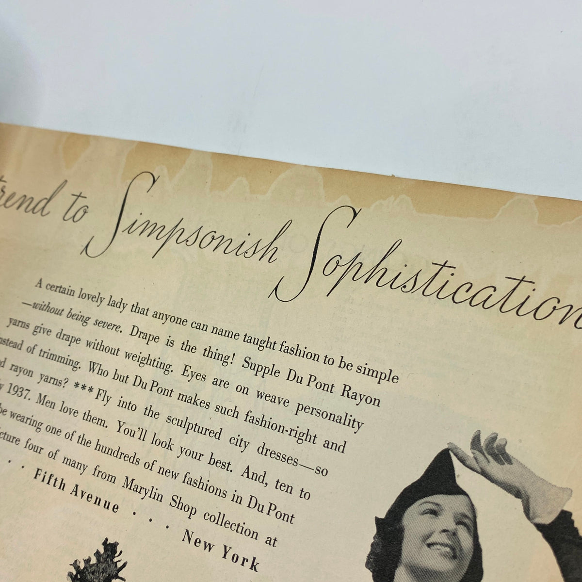 Close-up view of an advertisement for Du Pont Rayon fabric from The New Yorker Complete Magazine September 25, 1937, illustrating fashion trends of the era.
