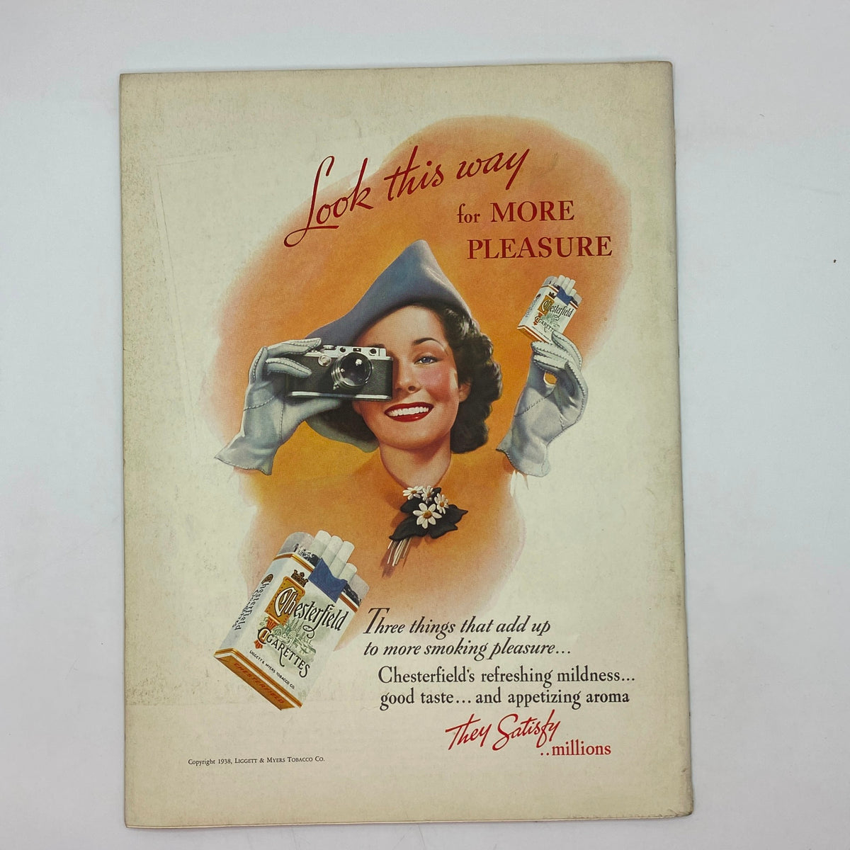 Vintage Chesterfield cigarette advertisement in The New Yorker Complete Magazine April 2, 1938 featuring a woman with a camera.