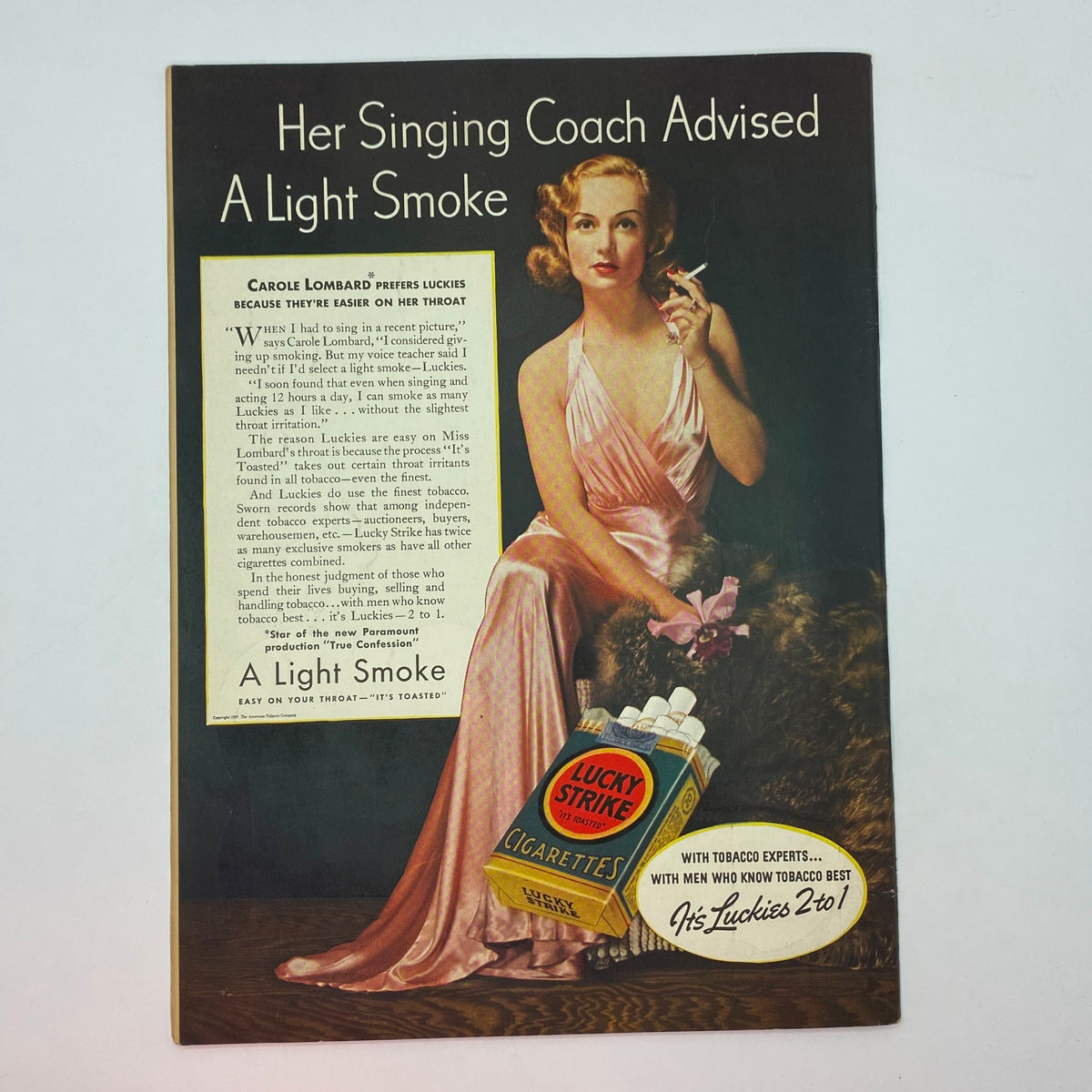 Vintage cigarette advertisement featuring actress Carole Lombard promoting Lucky Strike cigarettes with a glamorous pose, emphasizing a light smoke for ease on the throat, from The New Yorker Complete Magazine October 23, 1937.
