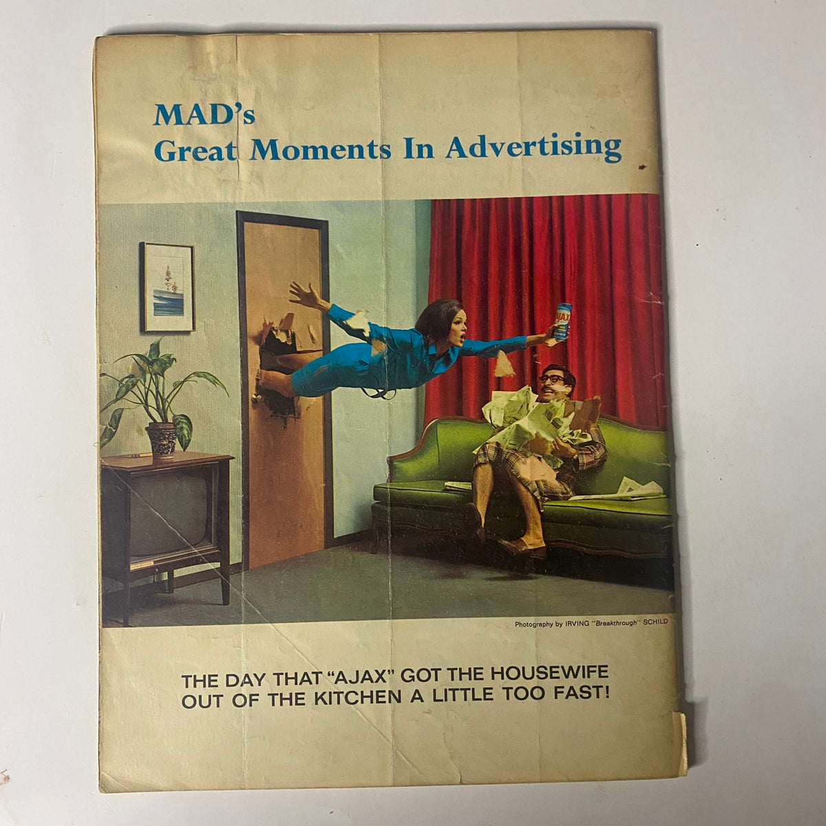 Back cover of Mad Magazine October 1965 No. 98 displaying a humorous advertisement parody featuring a woman humorously jumping out of a door while holding a cleaning product, representing the magazine's signature comedic style.