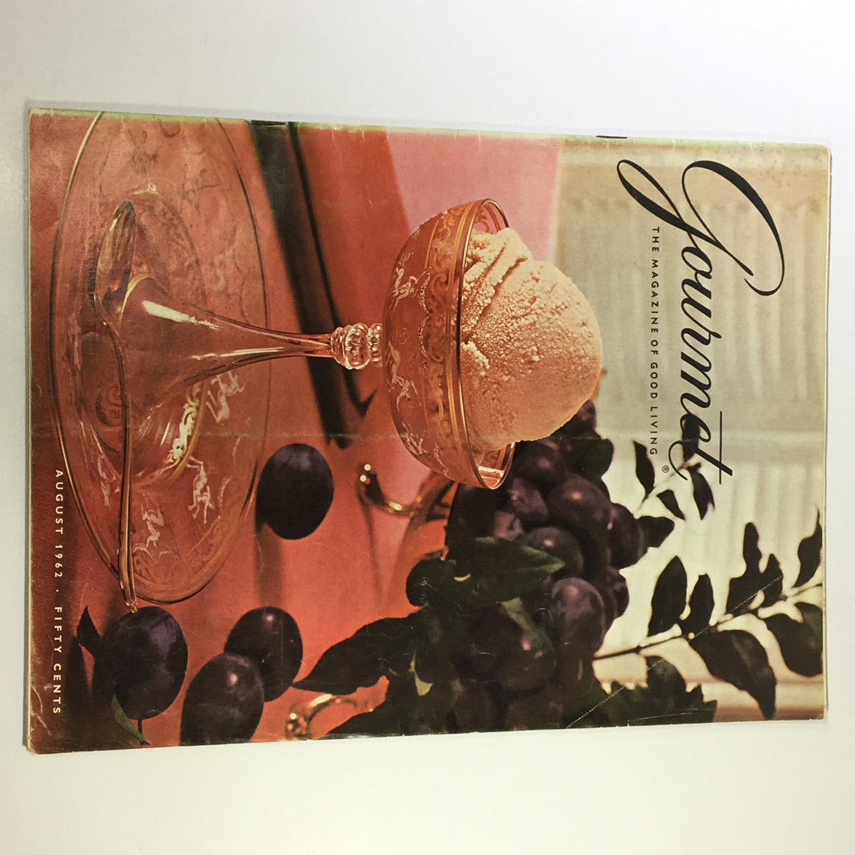 Cover of VTG Gourmet The Magazine of Good Living August 1962 featuring a dessert in an elegant glass bowl surrounded by grapes, highlighting themes of classic culinary arts and sophisticated entertaining.