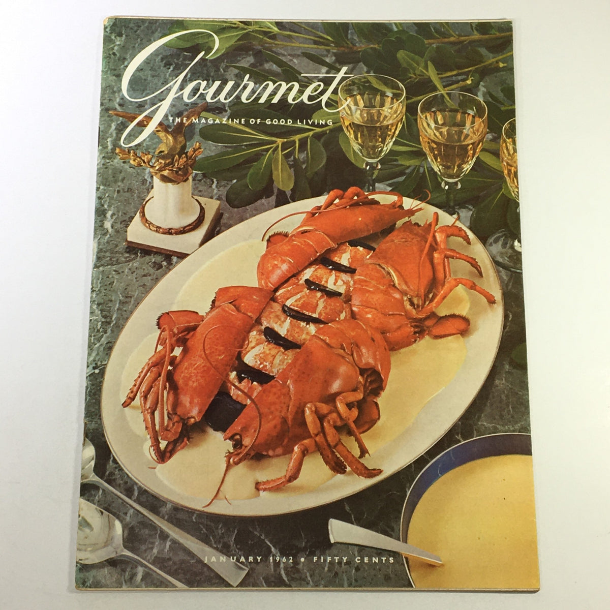 Cover of VTG Gourmet The Magazine of Good Living January 1962 featuring a gourmet dish of lobster on a platter, reflecting sophisticated dining from the early 1960s.
