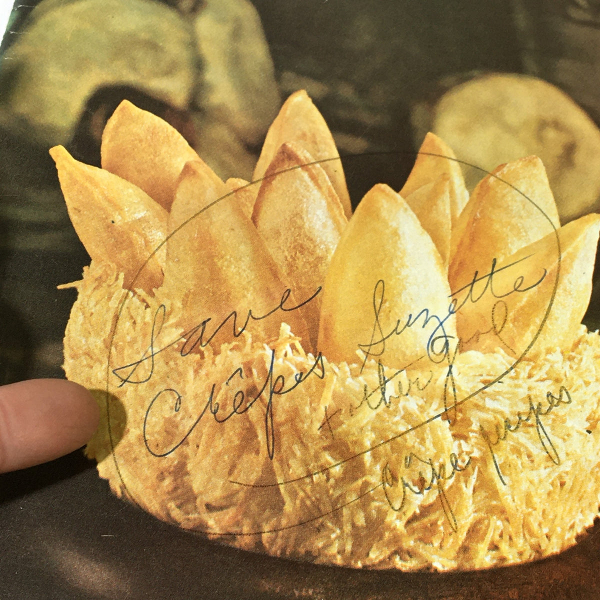 Close-up of the dessert featured on the cover of VTG Gourmet Magazine, March 1963, with handwritten notes about Crêpes Suzette.