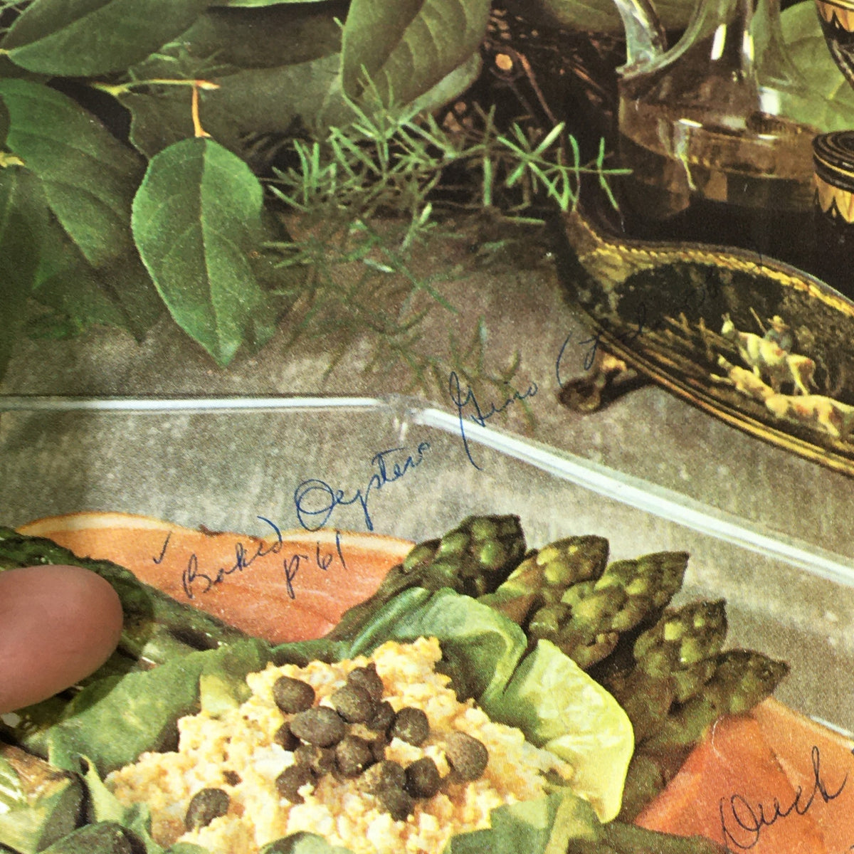Close-up of VTG Gourmet The Magazine of Good Living April 1963 showcasing handwritten notes and a dish with baked asparagus and egg salad, illustrating the magazine's vintage charm.