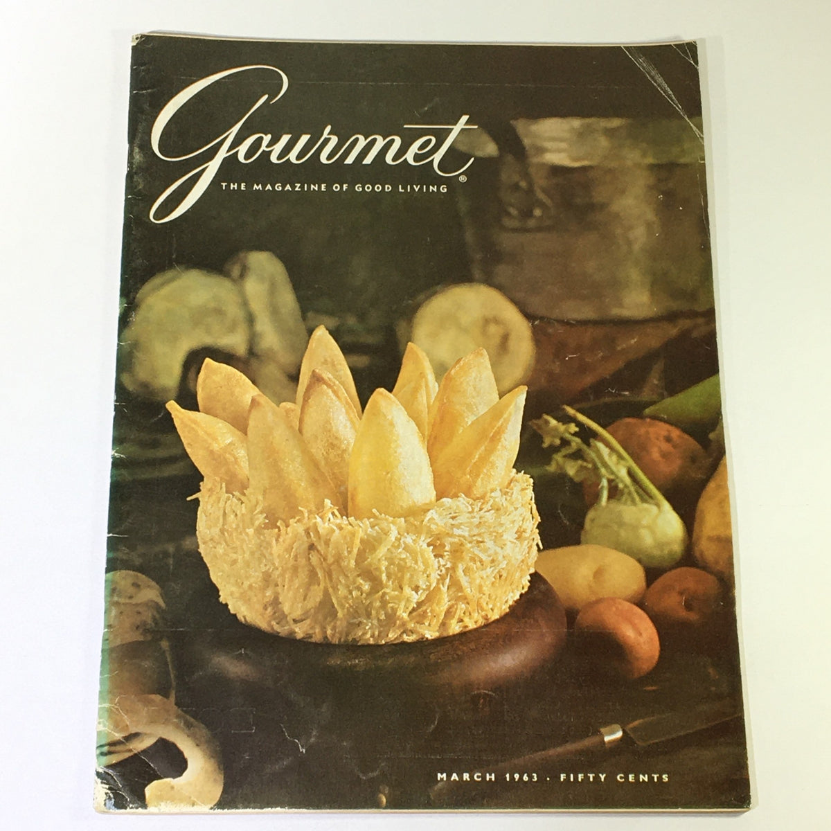 Cover of VTG Gourmet The Magazine of Good Living March 1963, featuring a beautiful arrangement of homemade snacks in a decorative bowl, symbolizing the culinary traditions of the Maya.