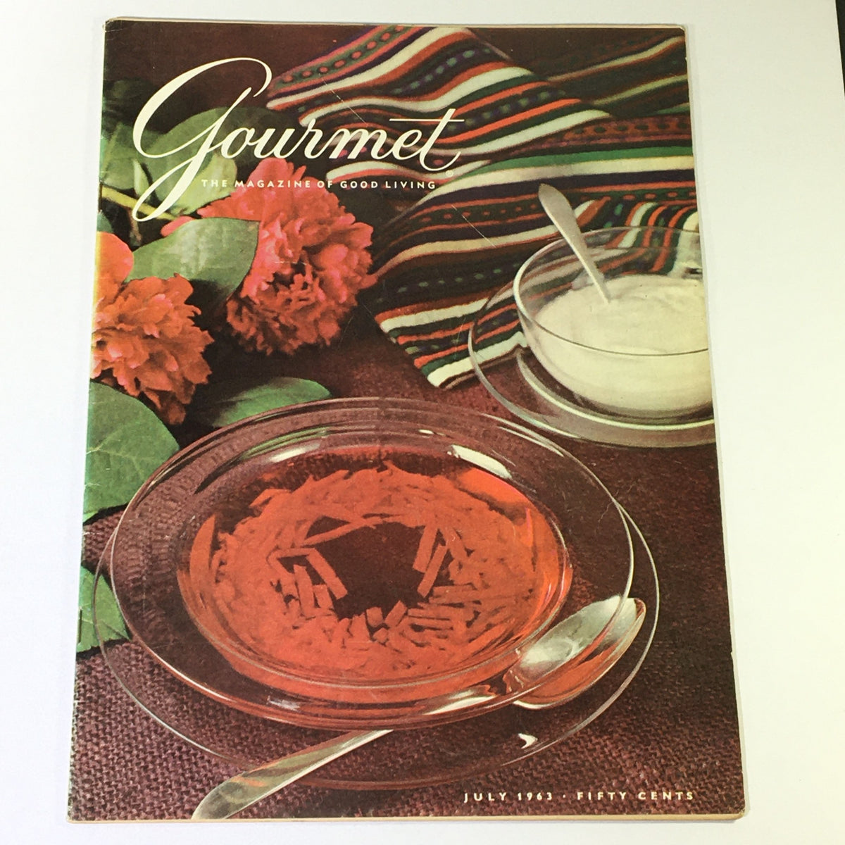 Cover of VTG Gourmet The Magazine of Good Living, July 1963, featuring a beautiful table setting with colorful flowers and culinary elements, highlighting the theme 'Happiness is Warm Croissant'.