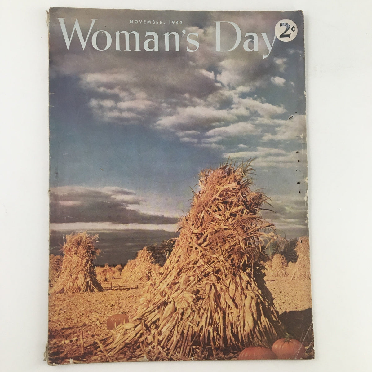 Cover image of Woman's Day Magazine November 1942 featuring autumn scenery and pumpkins, emphasizing the theme 'The Harvest Time of Pumpkins'.