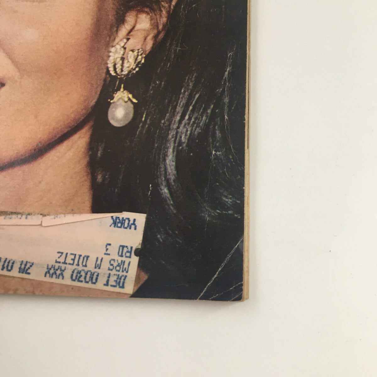 Close-up view of the cover of Newsweek Magazine October 28, 1968, highlighting Jacqueline 'Jackie' Kennedy Onassis with exquisite earrings and vintage appeal.
