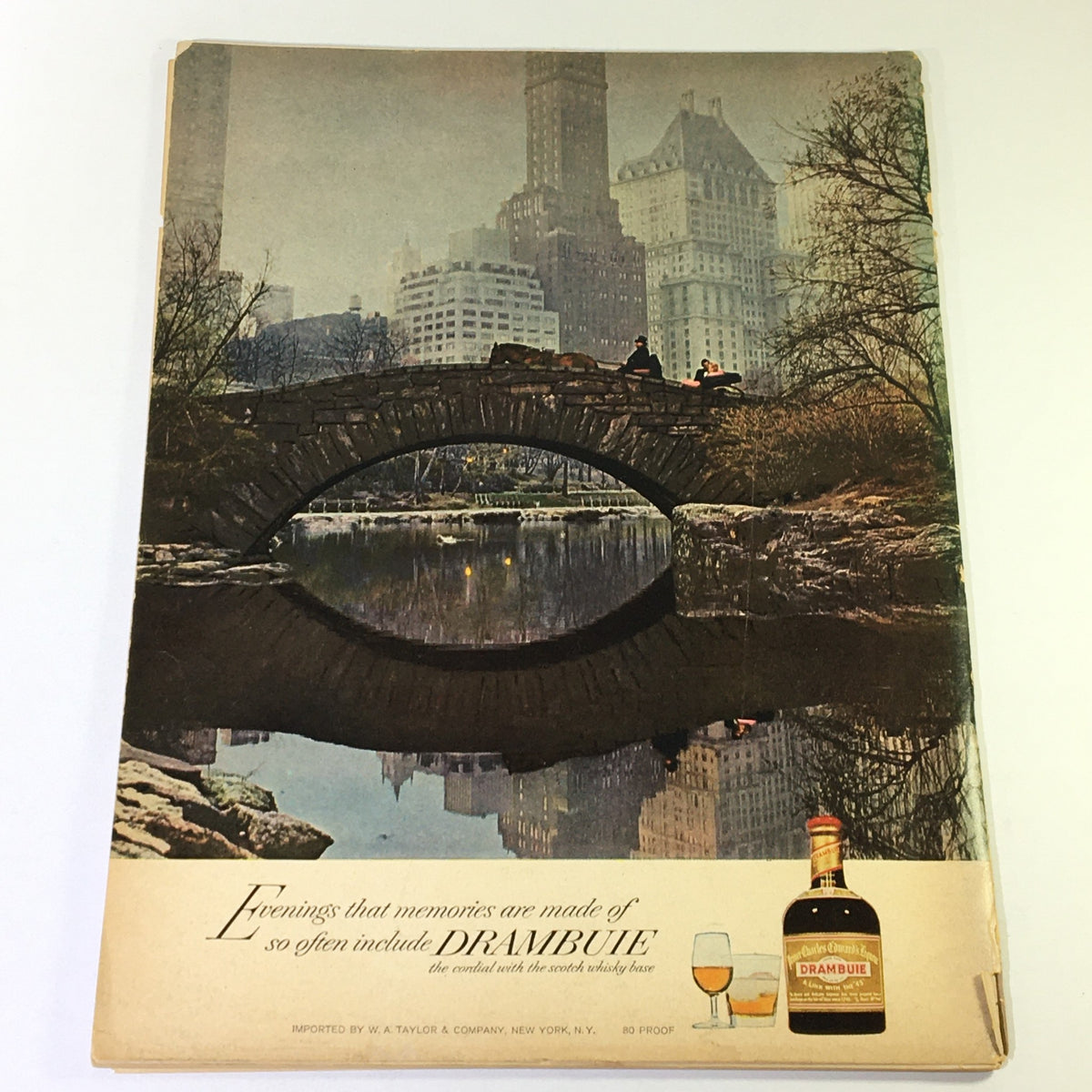 Historic scene from VTG Gourmet The Magazine of Good Living September 1965, depicting a picturesque bridge in a city park with a bottle of Drambuie.