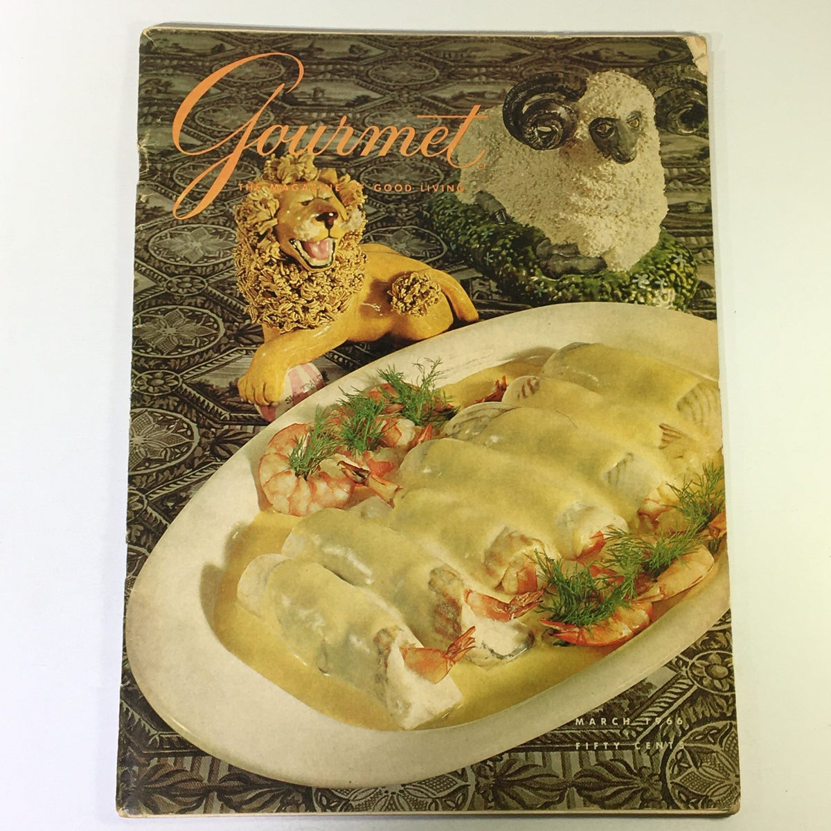 Cover of Gourmet Magazine March 1966 titled 'The Magazine of Good Living' featuring a decorative lion and a plate of gourmet dish with shrimp.