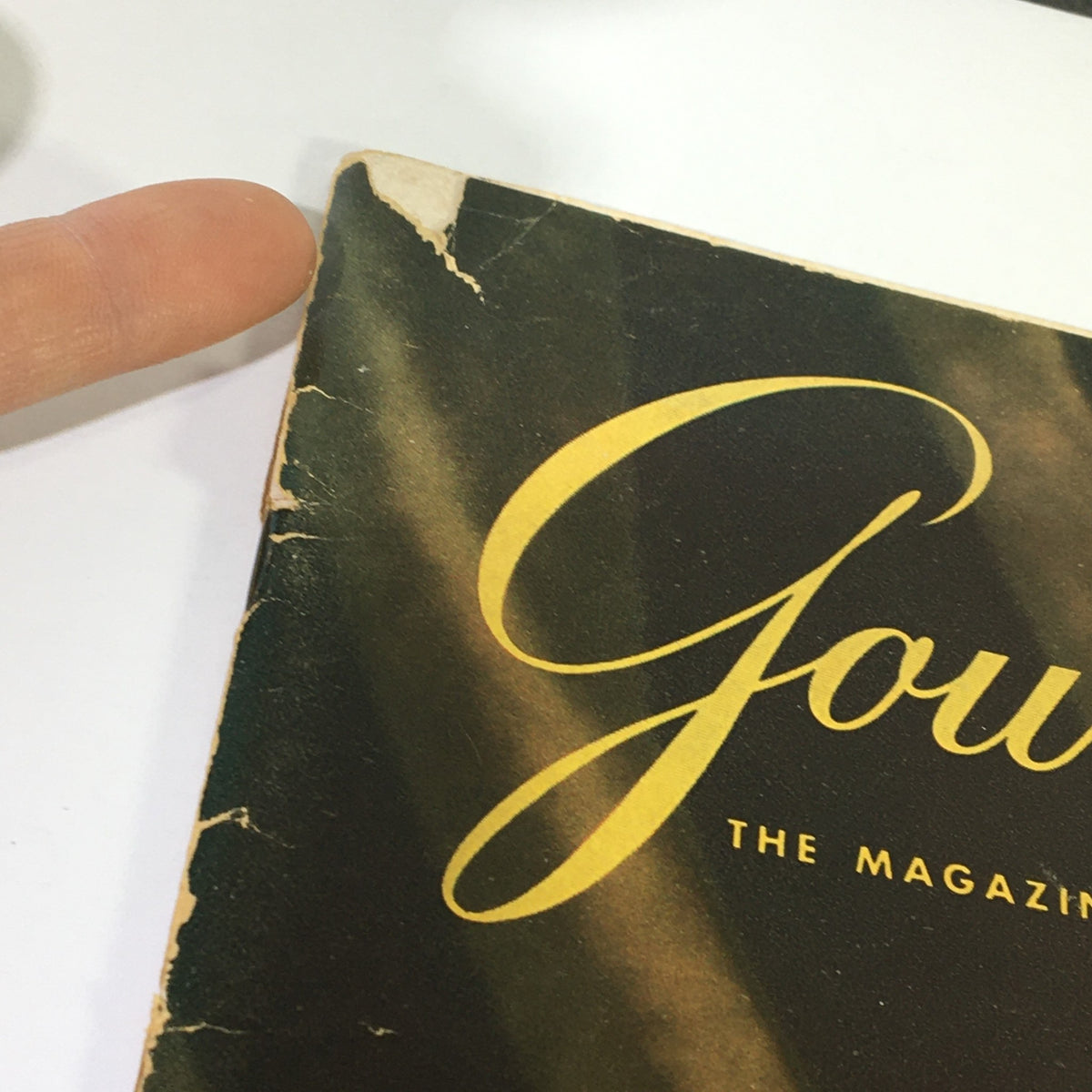 Close-up of the cover of VTG Gourmet The Magazine of Good Living January 1966 highlighting the magazine title and some wear on the edges.