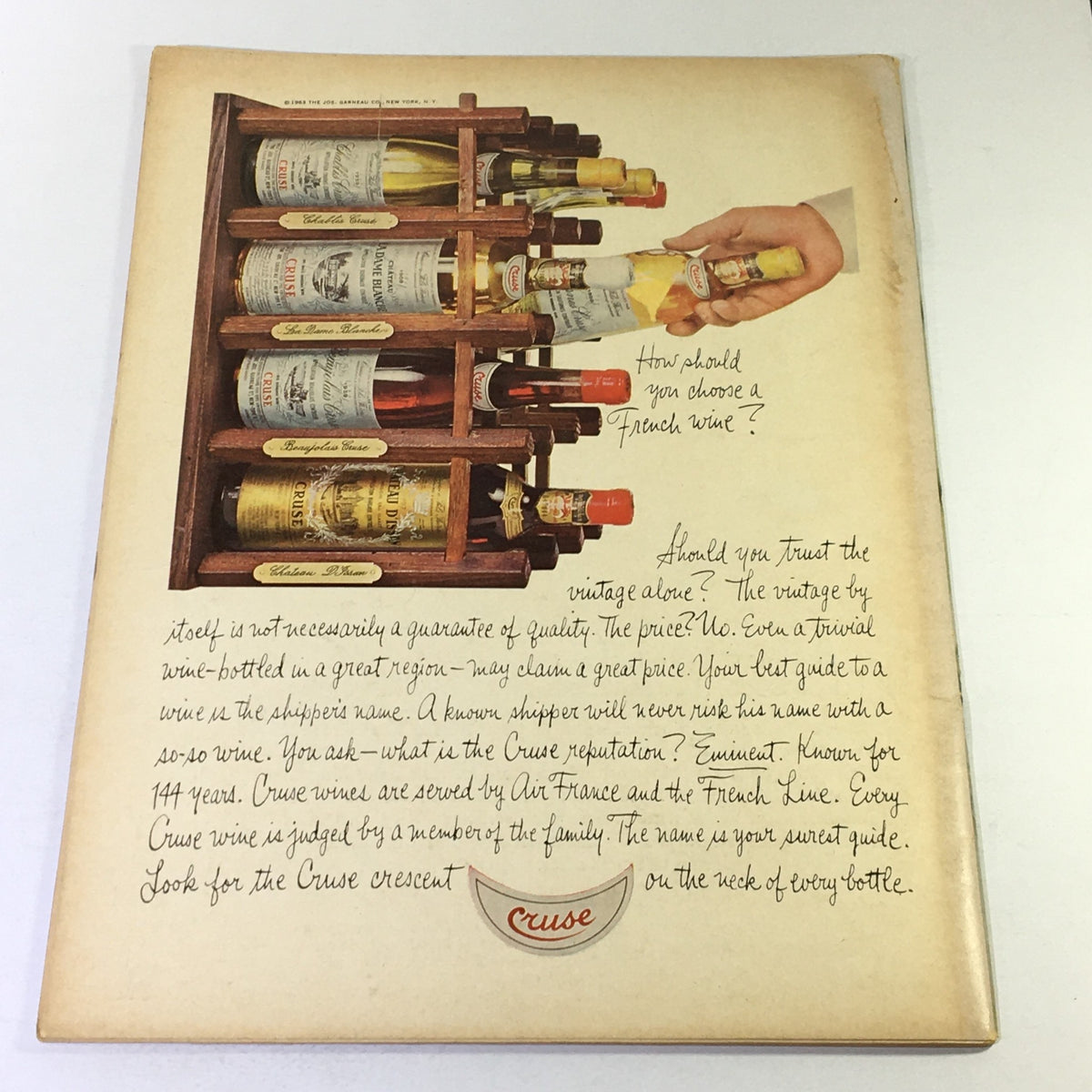 Back cover of the Vintage Gourmet Magazine from July 1966, showcasing a wine display with information about choosing French wine, part of a cherished collectible.