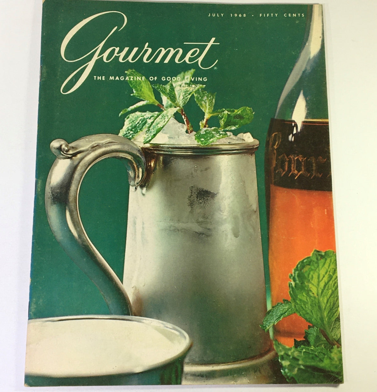 VTG Gourmet Magazine July 1968 cover featuring a silver mug with mint leaves and a bottle in the background, celebrating gourmet living.