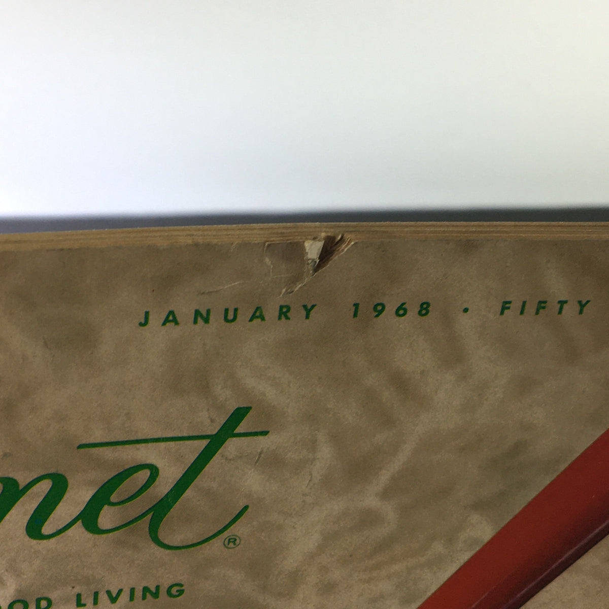 Close-up of the VTG Gourmet The Magazine of Good Living January 1968 showing minor wear and tear at the top edge, showcasing its vintage character.