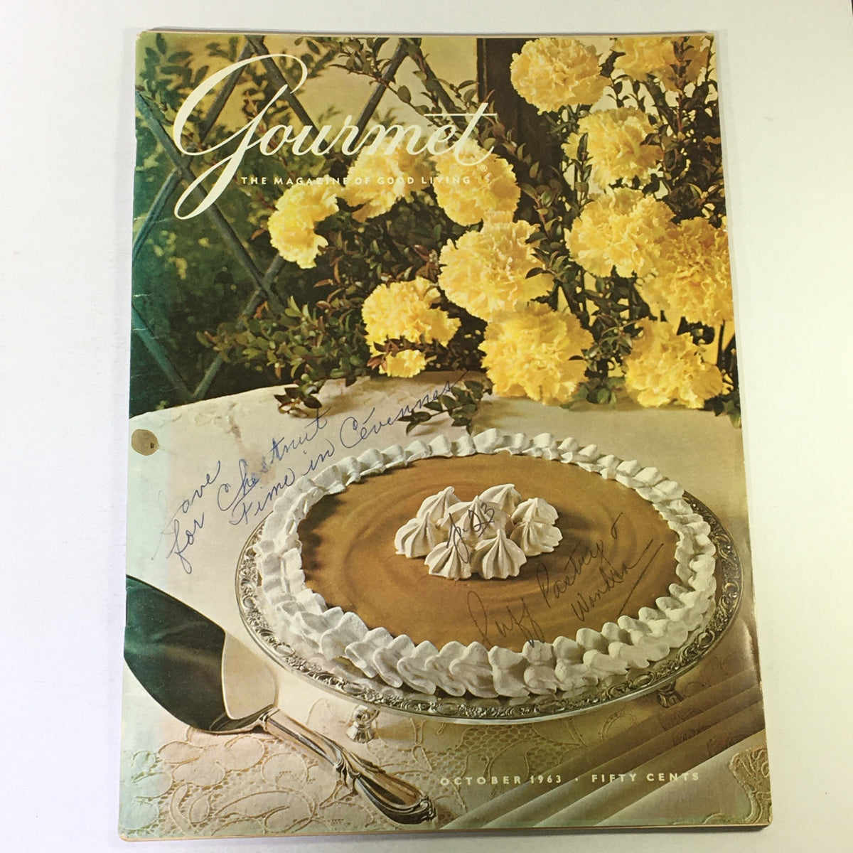Cover of VTG Gourmet The Magazine of Good Living October 1963 featuring a decorative cake on a silver platter, surrounded by vibrant yellow flowers and a handwritten note, showcasing vintage culinary elegance.
