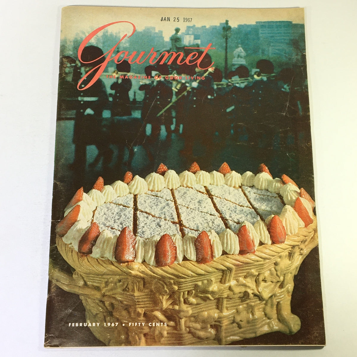 Cover of VTG Gourmet The Magazine of Good Living February 1967 - The Admirable Avocado, featuring a beautifully decorated dessert in a woven basket with strawberries, against a vintage urban backdrop.
