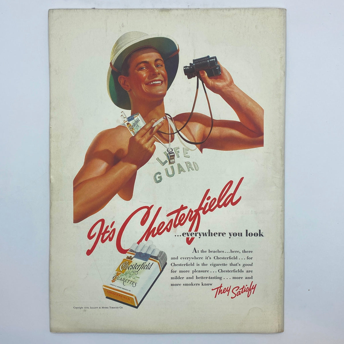 Cover of The New Yorker magazine dated July 29, 1939, featuring a vintage advertisement for Chesterfield cigarettes, showing a lifeguard holding a camera with a cheerful expression and a Chesterfield cigarette pack in his hand.