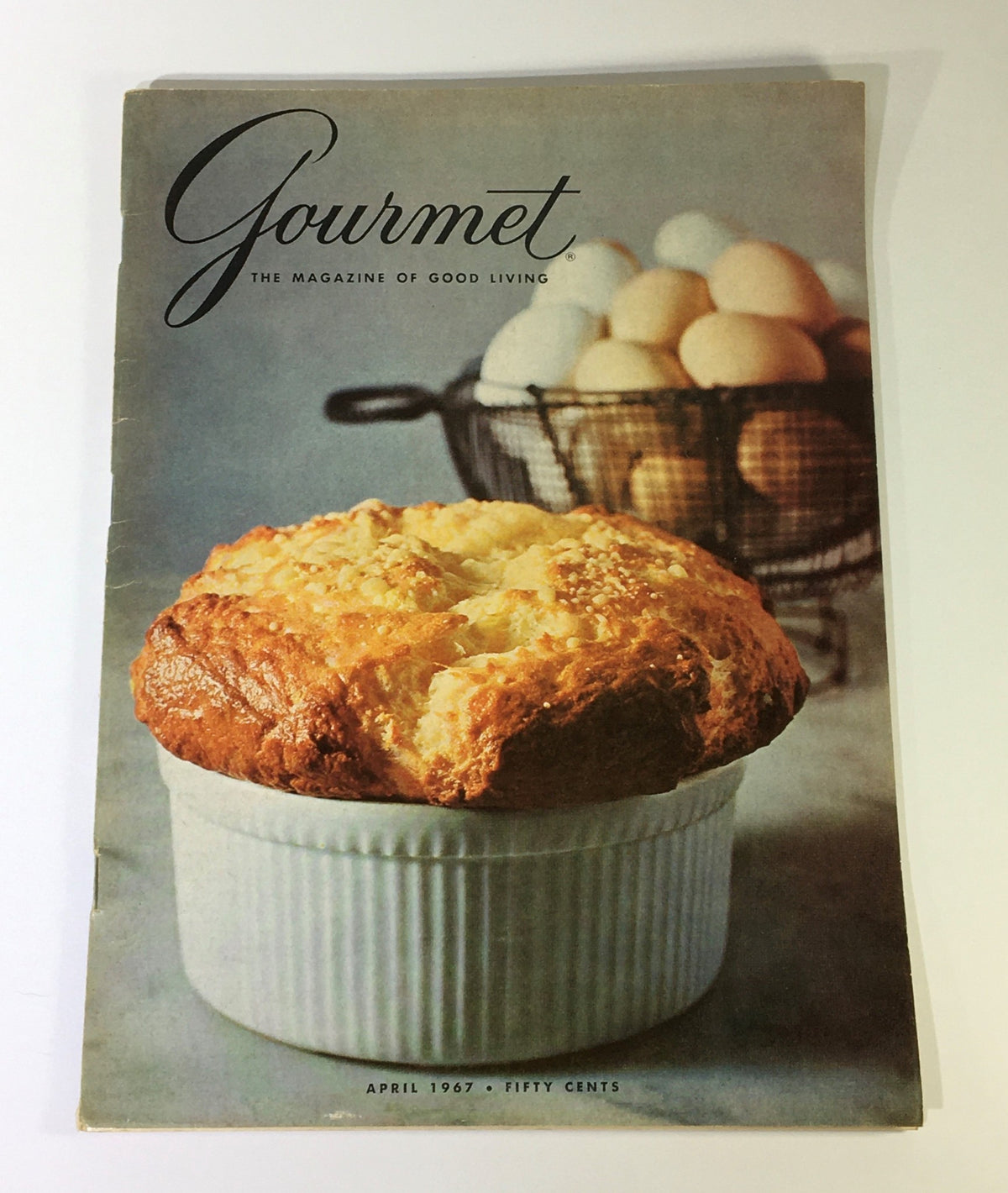 Cover of VTG Gourmet The Magazine of Good Living April 1967 featuring a golden soufflé in a white ramekin and a background of eggs in a basket.