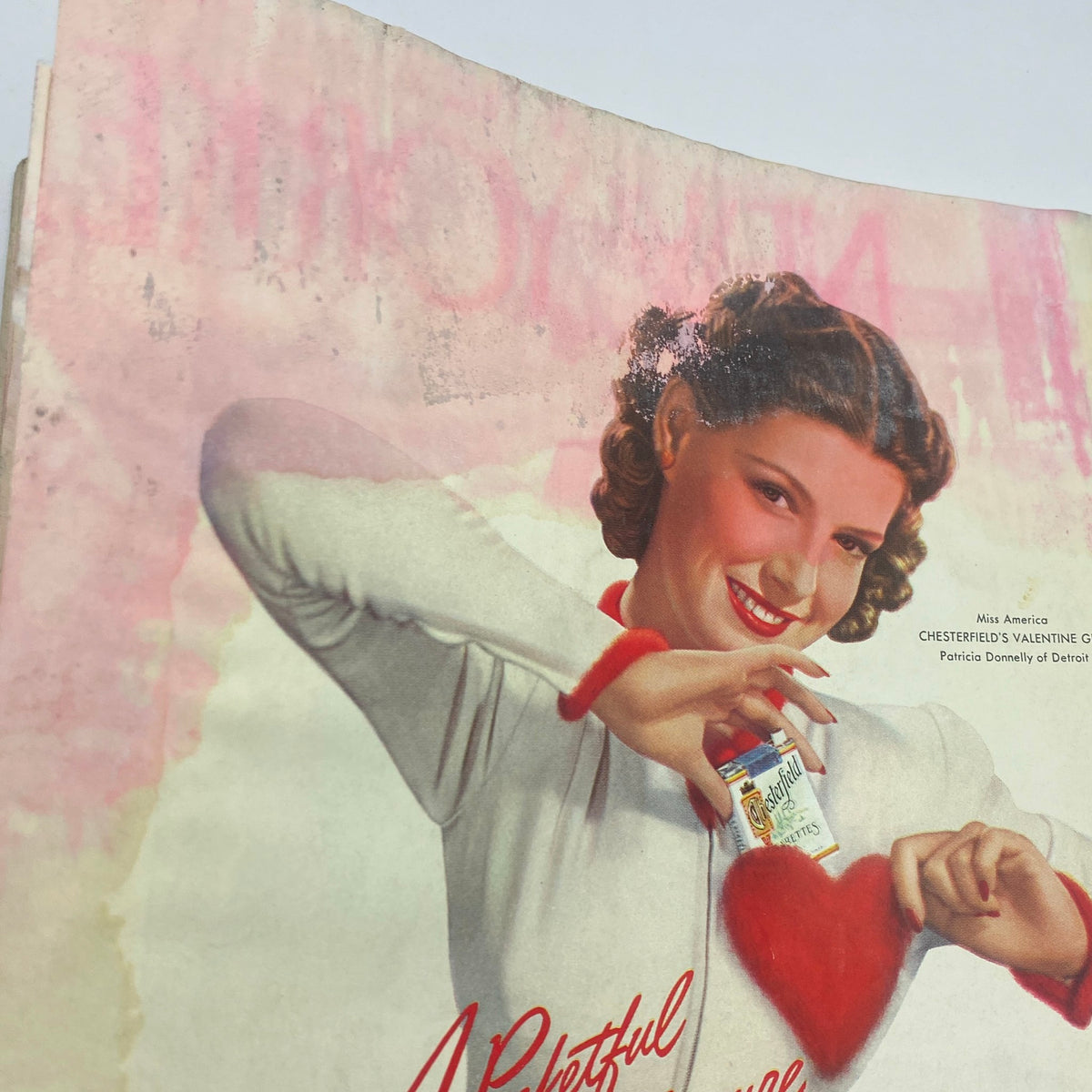 Vintage advertisement in The New Yorker Complete Magazine February 3, 1940, featuring a smiling woman promoting Chesterfield cigarettes.