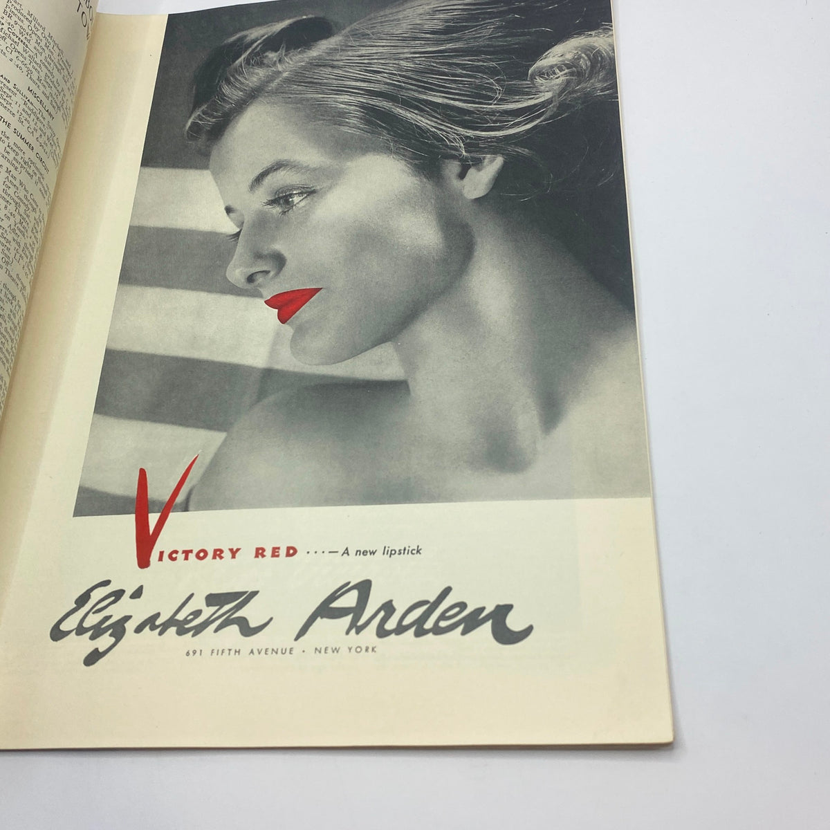 Vintage advertisement for Elizabeth Arden's Victory Red lipstick featured in The New Yorker magazine, September 13, 1941, showcasing a silhouette of a woman with bold red lips against a striped background.