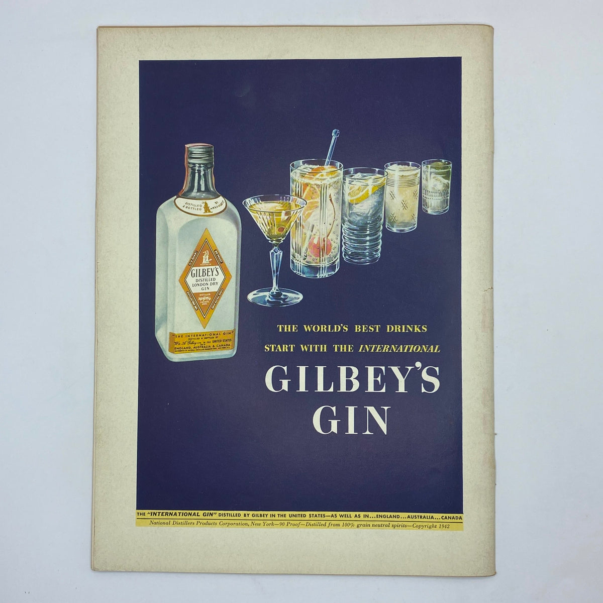 Vintage advertisement for Gilbey's Gin in The New Yorker Complete Magazine June 20, 1942, showcasing cocktails and a stylish bottle design.